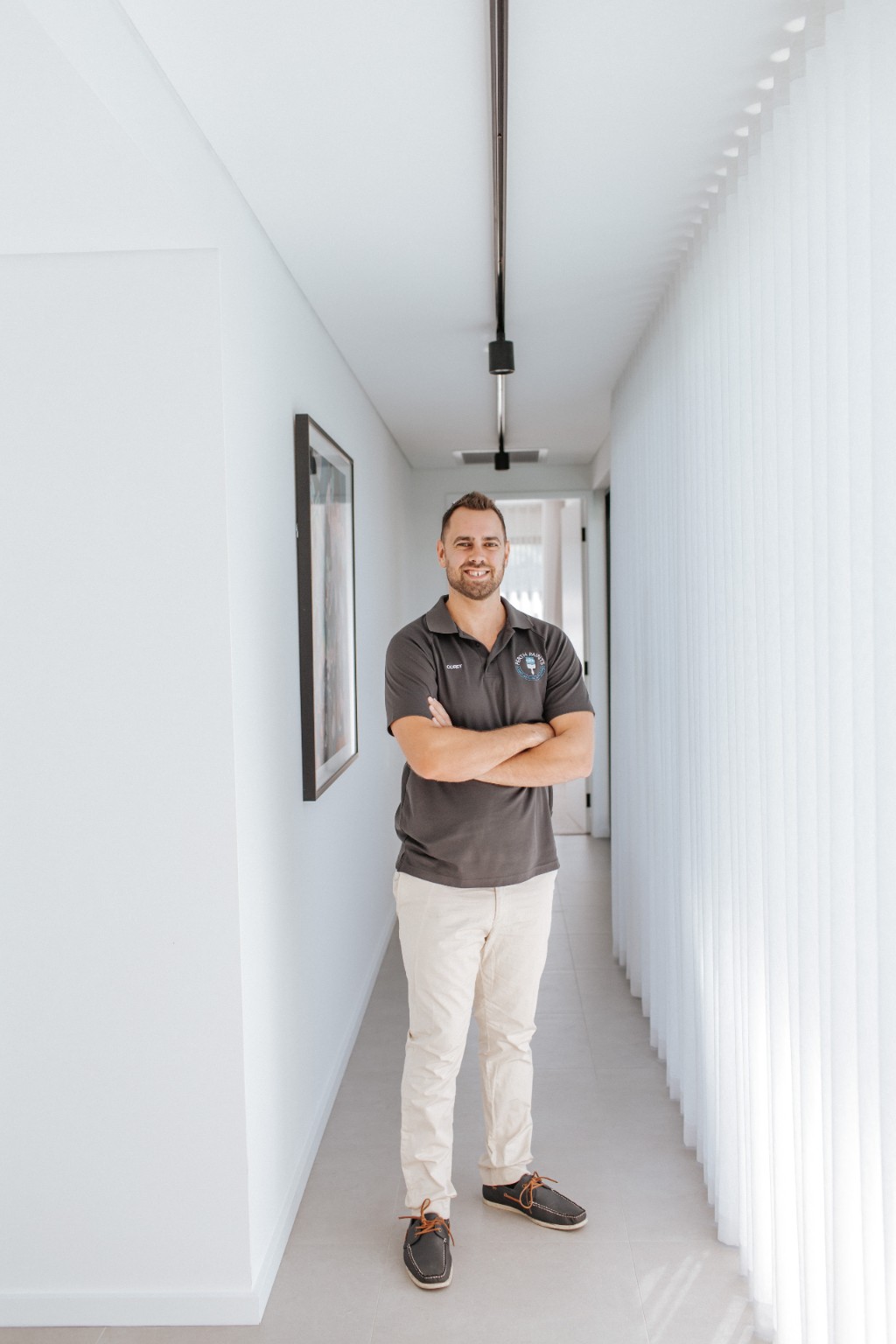 Corey Hicks, author and Working Director, standing inside a completed home