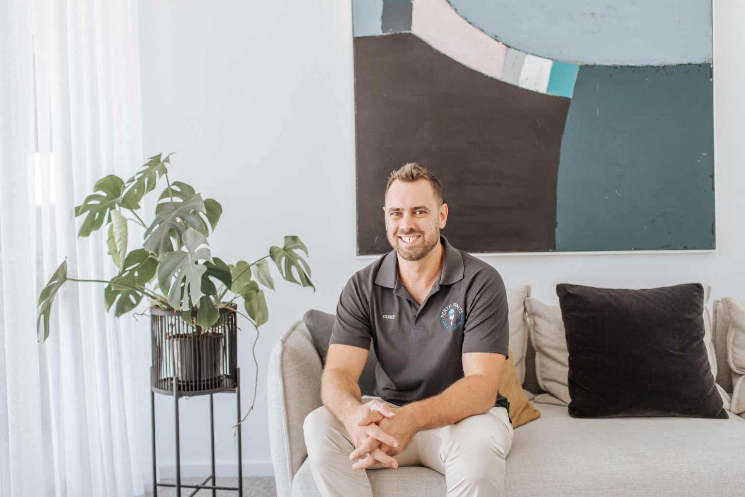 Corey Hicks seated in a completed modern home